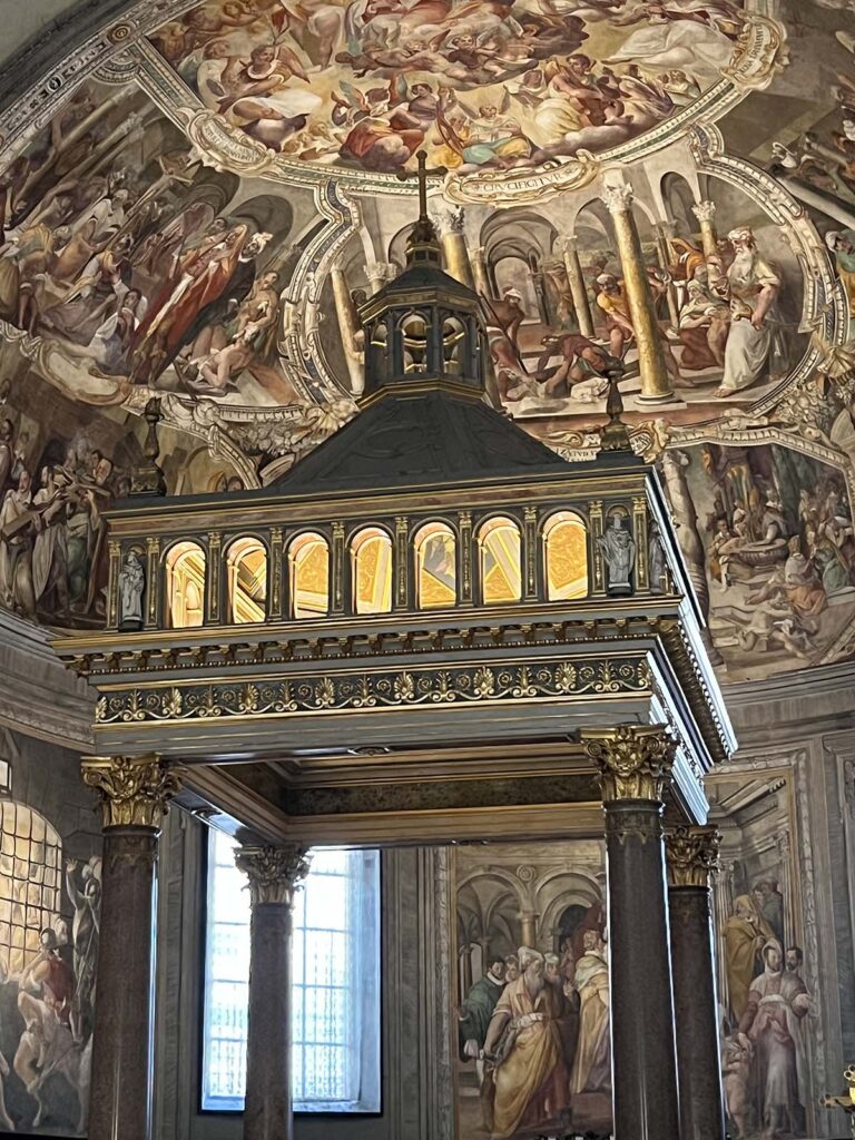 Interno dell’abside della basilica di San Pietro in Vincoli a Roma, con il ciborio decorato e gli affreschi rinascimentali sullo sfondo.